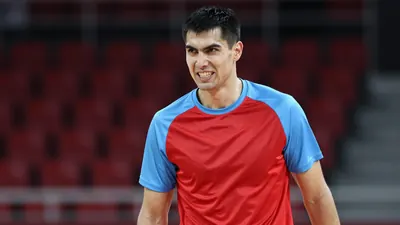 Mid-30s forward, athletic build, waist-up, head turned slightly left, fierce grin, eyes sharp;